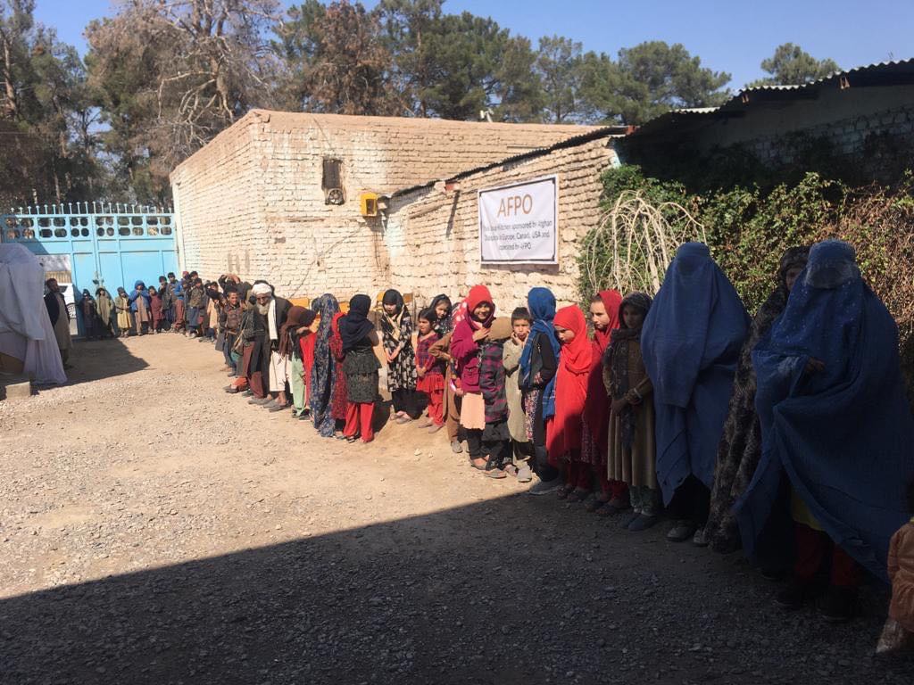 A group of individuals lining up in front of AFPO soup kitchen to break their fast.